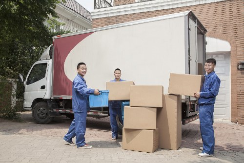 Furniture pick-up team handling a sofa collection in a Stockwell flat
