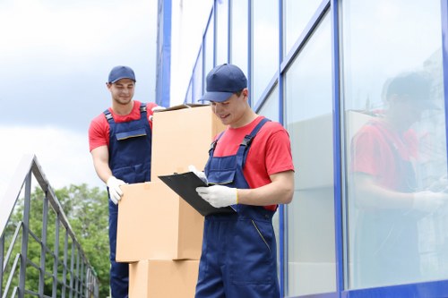 Professional movers transporting household items in a van
