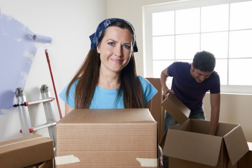Local moving team transporting boxes and furniture in Stockwell